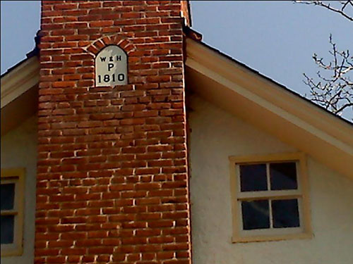 photo of date plate on chimney of house reading W&H P 1810 (William and Hannah Penrose 1810) 
