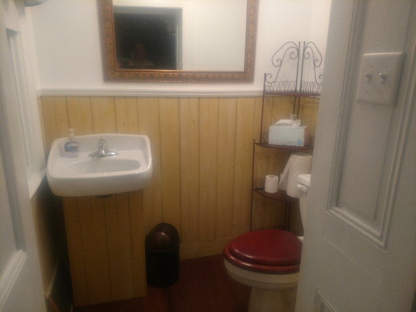 small powder room with yellow pine wainscotting