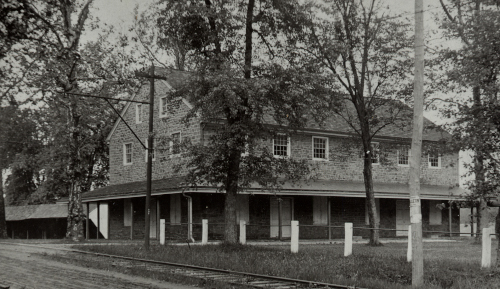 photo of Horsham Meeting House with trolley tracks on Doylestown Pike in front