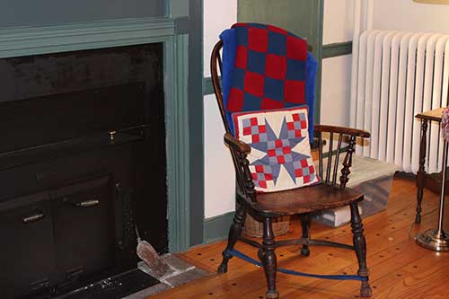 photo of chair next to fireplaces 