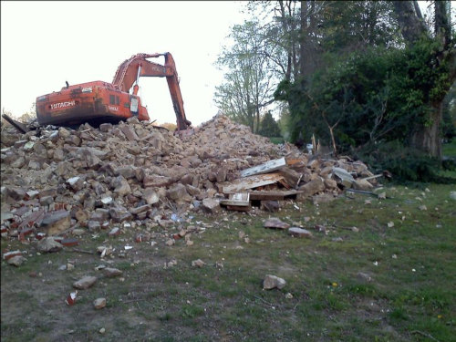 photo of crane on rubble of Kenderdine House